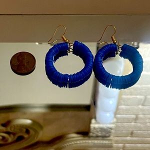 Round earrings in blue or teal colors